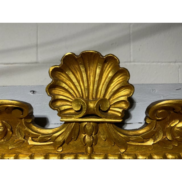 This vintage Italian carved giltwood and shell decorated wall mirror is a true work of art. Crafted with precision and...