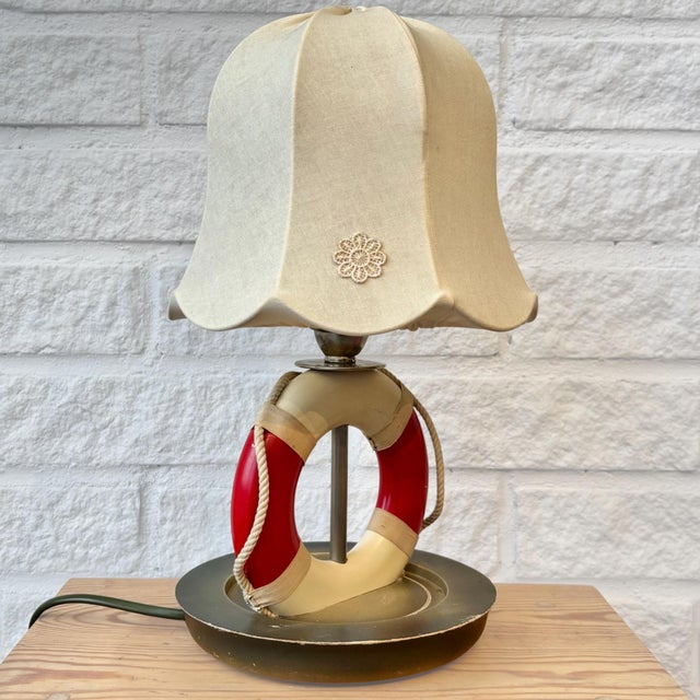 A rare Swedish table lamp designed as a stylized lifebuoy, produced in Stockholm during the 1940s by Olof Heijke. The...