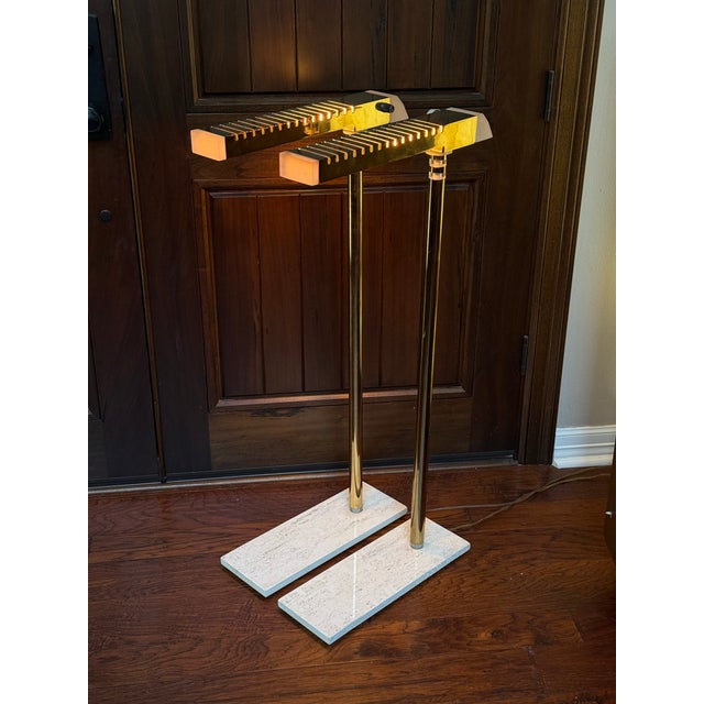 Gorgeous pair of floor lamps made of brass with travertine stone bases and lucite accents. In excellent condition! Both...