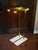 Gorgeous pair of floor lamps made of brass with travertine stone bases and lucite accents. In excellent condition! Both...