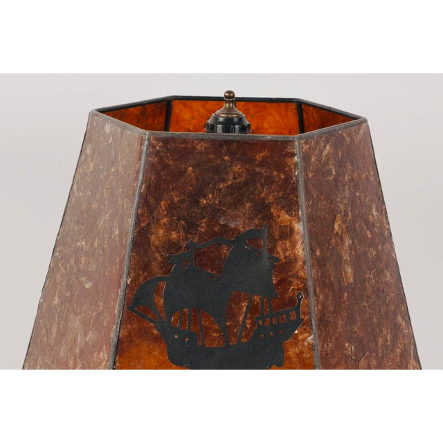 A wonderfully atmospheric vintage table lamp featuring a sculptural bronze-finished base formed as a pair of elegant...