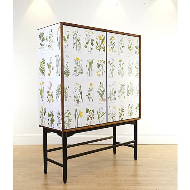 Beautiful mid century cabinet in very good condition covered with illustrations Nordens Flora by C.A.M Lindman, the same...