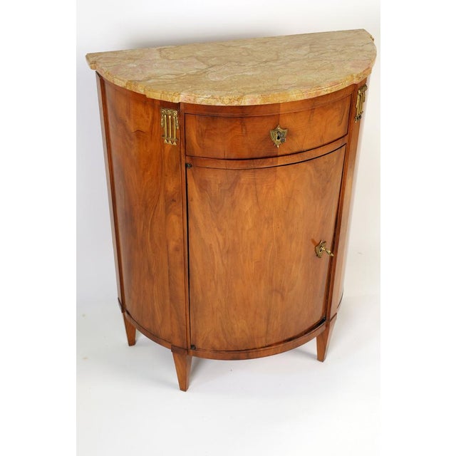 Elegant half-cabinet with a semi-circular marble top, small drawer with box lock and key, convex door with box lock and...