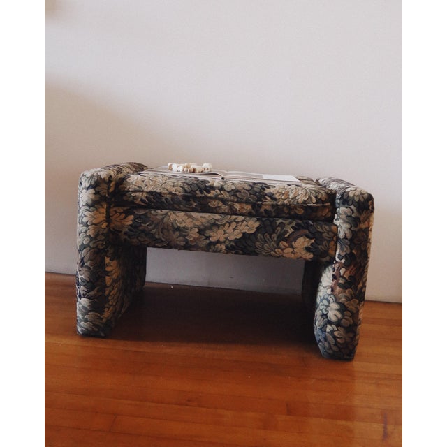 Vintage Parsons style upholstered ottoman featuring substantial fully upholstered legs and a loose seat cushion wrapped in...