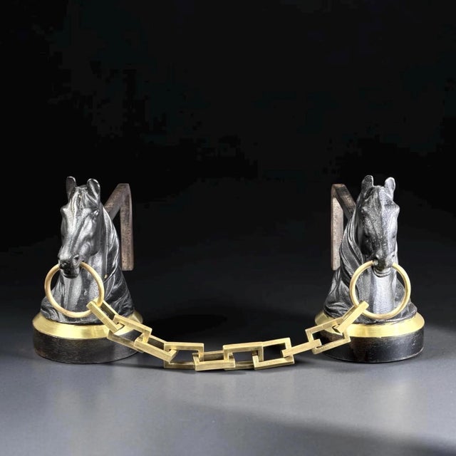 An elegant pair of French horse-head andirons created in the style of Jacques Adnet during the 1950s. Combining sculptural...