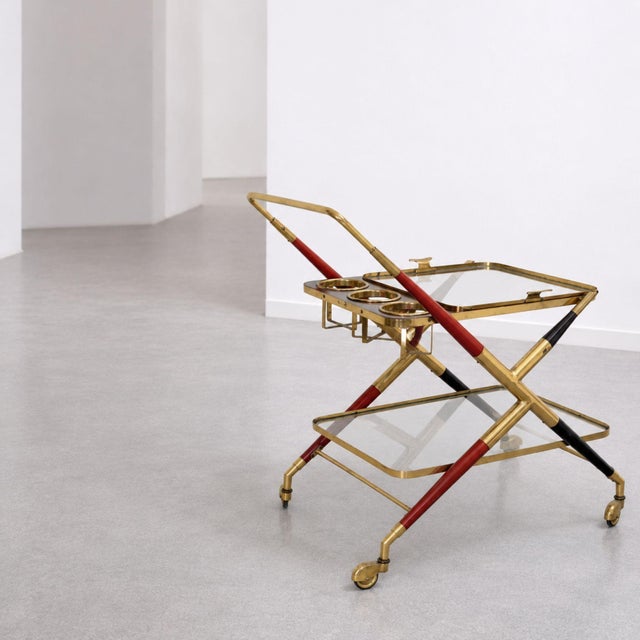 Elegant Italian Mid-Century Modern bar cart from the 1950s Attributed to Cesare Lacca, crafted in brass, glass and wood....