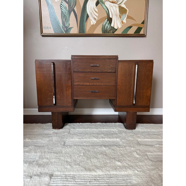 Gorgeous antique art deco tiger oak (quarter-sawn oak) sideboard/buffet featuring a stepped central drawer stack flanked...