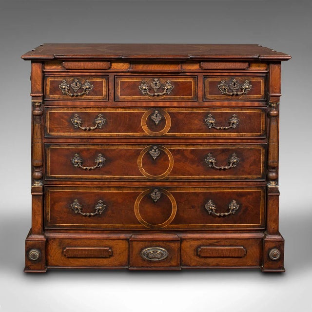 This is a vintage decorative chest of drawers. An English, mahogany and walnut drawing room storage cabinet in Georgian...