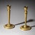 Pair of brass candle holders with circular disc bases decorated with a surrounding leaf frieze. Stylized claw feet and...