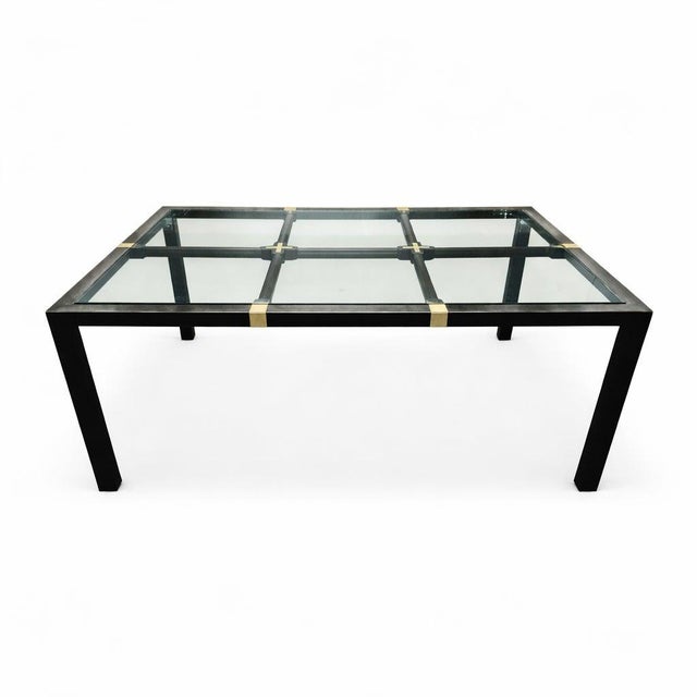 This Mid-Century Hollywood Regency Brushed Metal & Brass Dining Table with Glass Top has a clean linear profile and...
