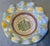 A retired MacKenzie-Childs Aalsmeer pattern bowl with a ruffled rim, hand-painted in soft blue lattice and yellow dots...