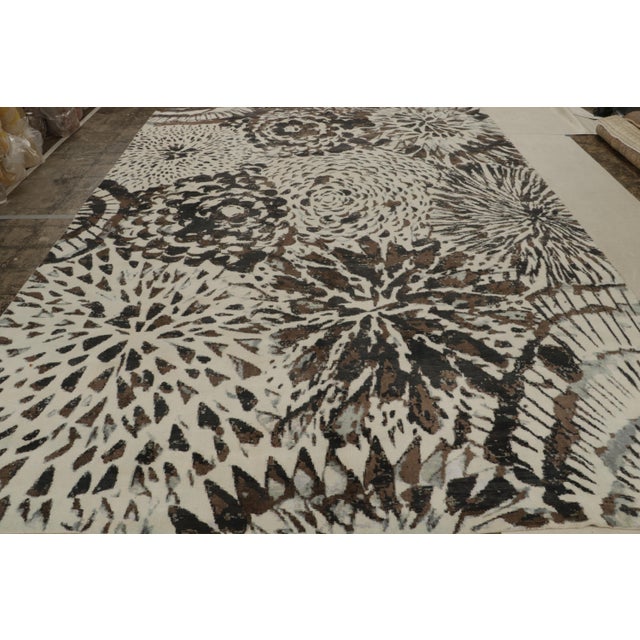 Hand-knotted in wool and silk, this 10x14 modern rug is inspired by one of the more mid-century modern French Deco styles...
