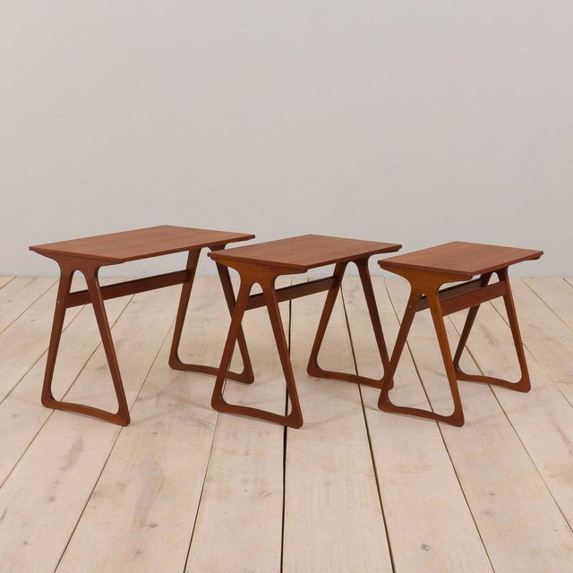 A stunning set of three vintage nesting tables made of teak and designed in the style of j. Andersen cfc comes from...