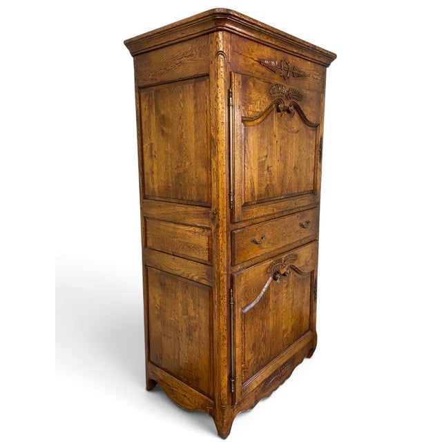 This exceptional late 18th to early 19th-century French Provincial "Homme Debout" (standing man) cabinet beautifully...