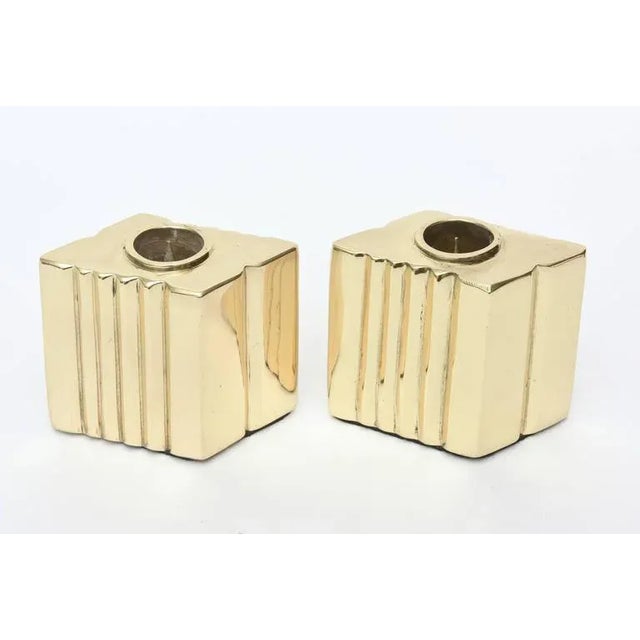This pair of vintage polished brass candlesticks can be formed in many different ways. The ribbed detail of the brass on...