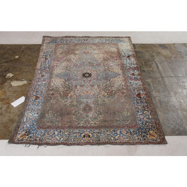 A 4x6 antique Persian rug of Farahan design in blue and pink, hand-knotted in silk circa 1890-1900. Some distress in the...