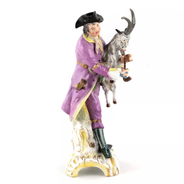 The porcelain figurine "A young man with a pipe, a goat" symbolizes the air from the cycle of four elements. Sign...