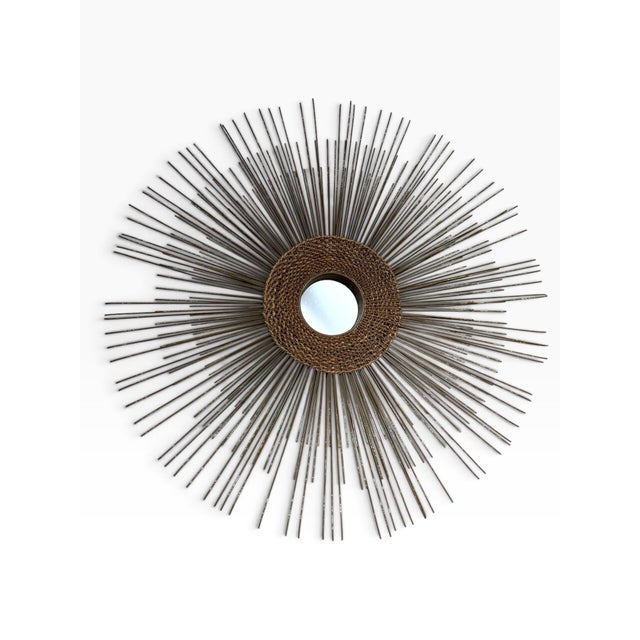 A spectacular vintage Mid-Century Modern sunburst mirror with a dramatic sculptural silhouette and an exceptional...