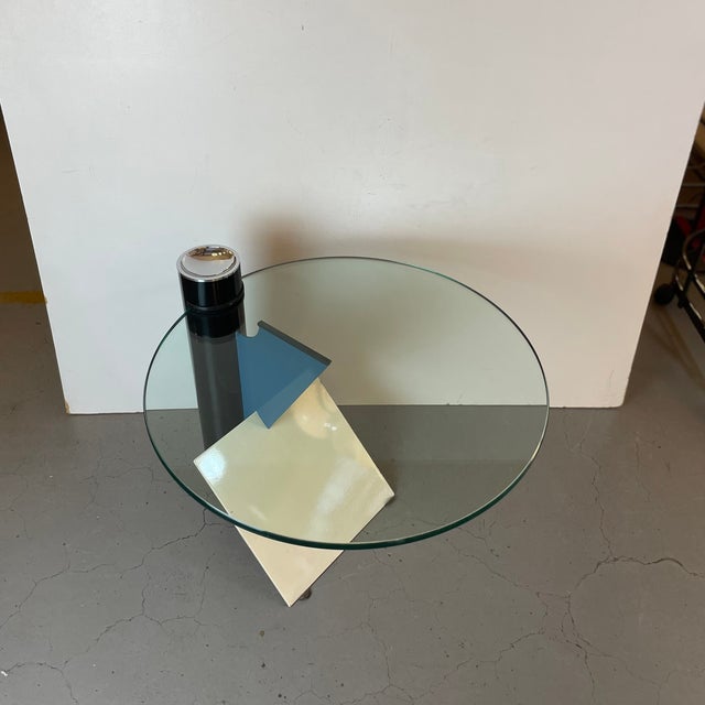 Rare Postmodern side table made of black, blue and beige enameled steel base with a disc of glass table top and a chromed...