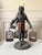 Vintage metal "Blackamoor" Bird Seller statue made by Petites Choses. A highly detailed, muscular figure depicted as a...