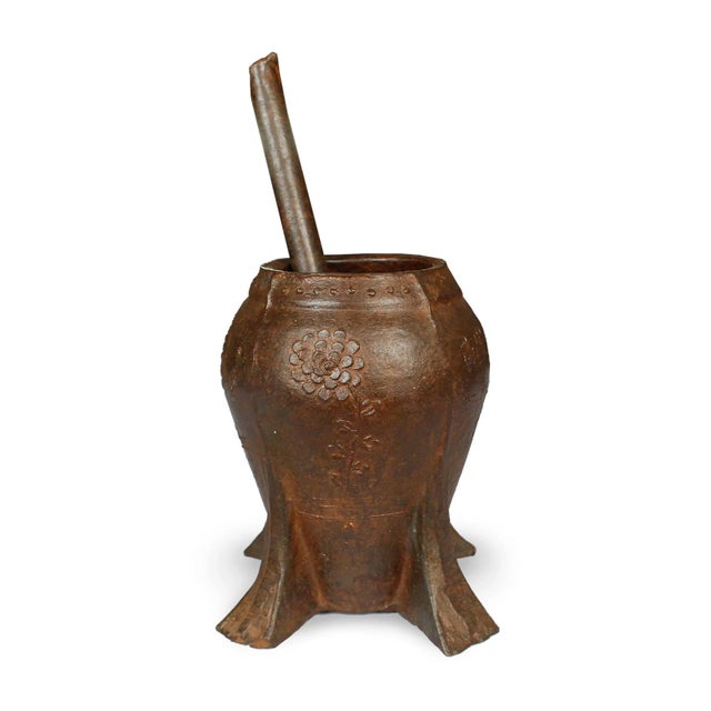 This vintage iron mortar from China's Shanxi province was cast in low relief with a delicate chrysanthemum in bloom....