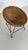 A prized design classic. Comfortable wicker armchair, cone-shaped and woven from willow, with an elegantly curved, black...