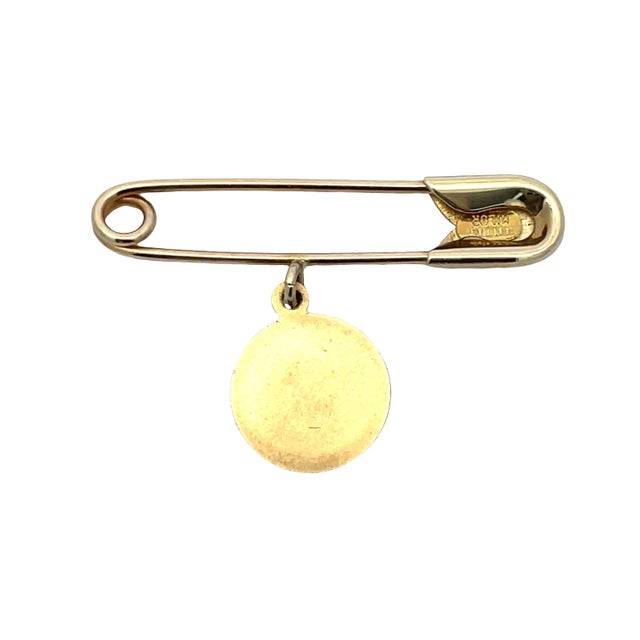 Charming vintage 14k yellow gold clip pin featuring a dangling round cupid token with detailed relief. Total weight: 1.4...