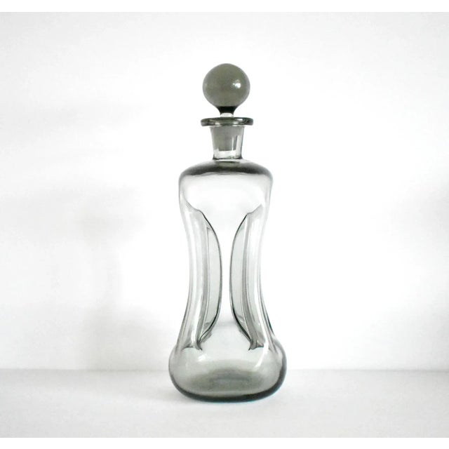 A vintage, mid-century smoky blown glass decanter designed by Jacob Bang for Holmegaard, Sweden, with pinched sides - the...