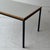 c. 1960s. Finland. White laminate top with wood trim and metal base.