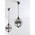 A magnificent pair of early 20th century English pendant light fixtures in globe form–very similar to an armillary...