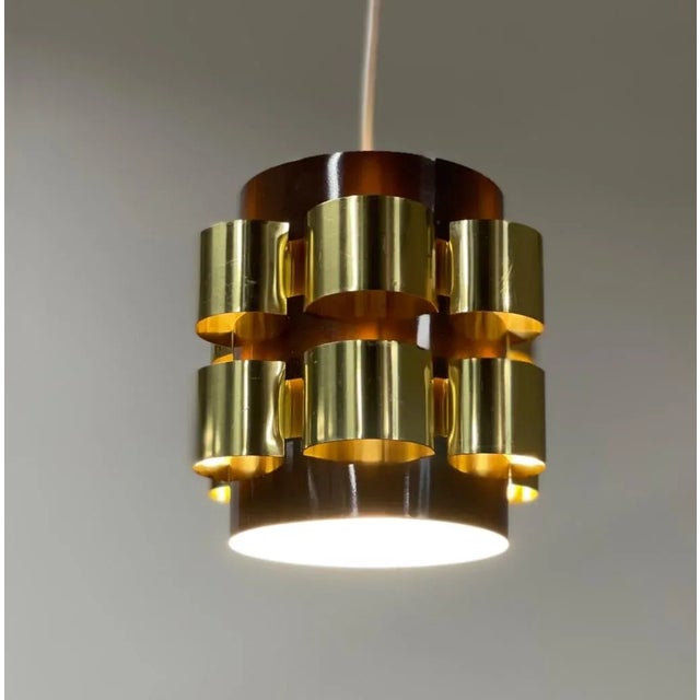 Small Danish pendant designed by Werner Schou for Coronell Elektro, Denmark around 1970. This lamp gives a sculptural...