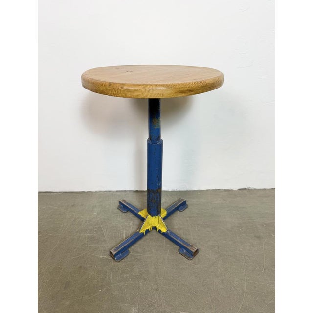 Vintage industrial stool. It features a blue iron leg and a solid wooden seat. The diameter of the seat is 35 cm. The...