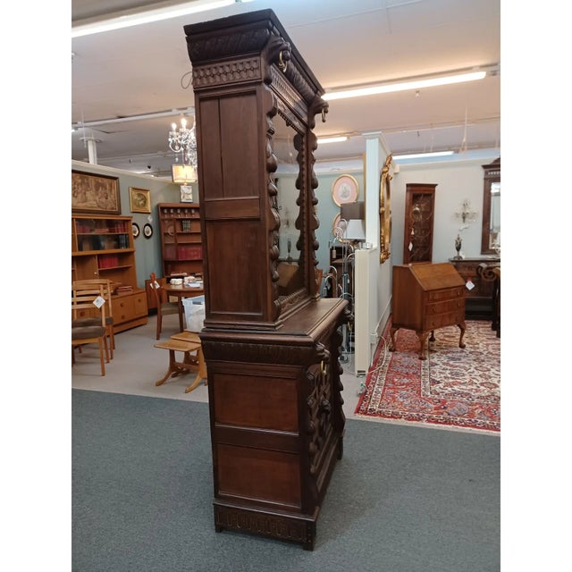 Antique 19th century carved oak narrow bookcase/ hunt cabinet. Upper cabinet having glass door with two wood interior...