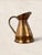 A beautifully proportioned antique English hammered copper water ewer dating to circa 1920. Featuring a flared pouring...