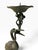 A vintage Japanese bronze pricket candlestick featuring a crane standing on a turtle and holding a lotus leaf candle pan...