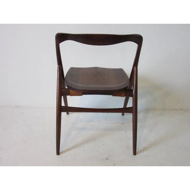A studio crafted oiled black walnut sculptural chair in the manner of George Nakashima designed and made by Japanese...