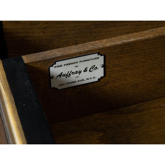 A Louis XV French style black lacquered desk from the mid 20th century by maker Auffray and Co, with leather top, gilt...