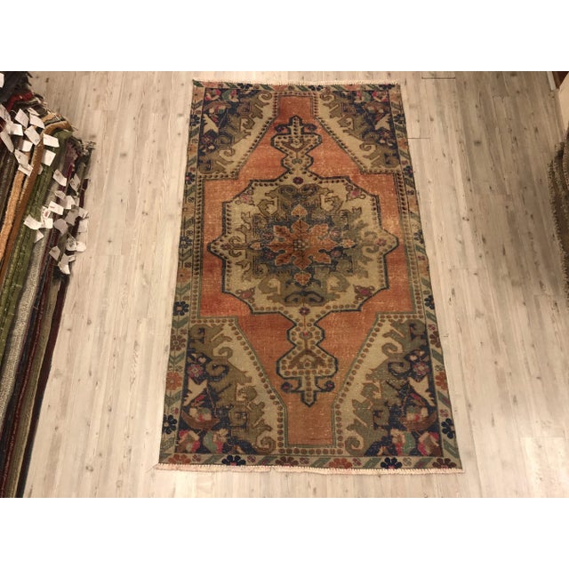 This is a vintage Turkish Oushak rug from the 1960s. The piece was hand-knotted.
