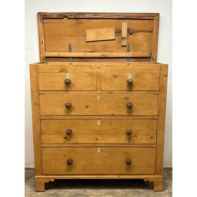 The most captivating antique furniture often keeps a little secret. At first glance, this 19th century English pine piece...