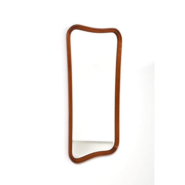 Elegant mid-century wall mirror designed and manufactured in Sweden by Glas & Trä Hovmantorp during the 1940s. This mirror...