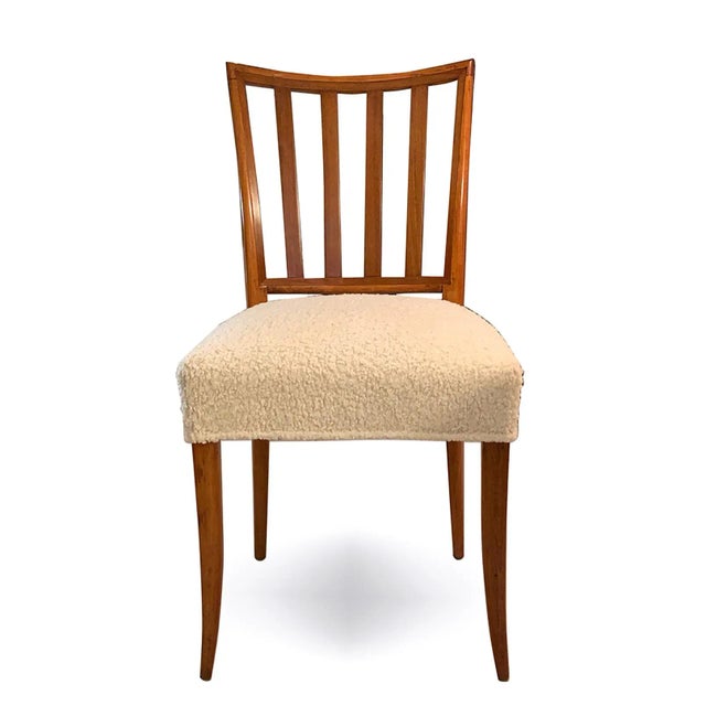 A pair of mid-century slat-back dining chairs re-upholstered in Boucle fabric. Set of 2.