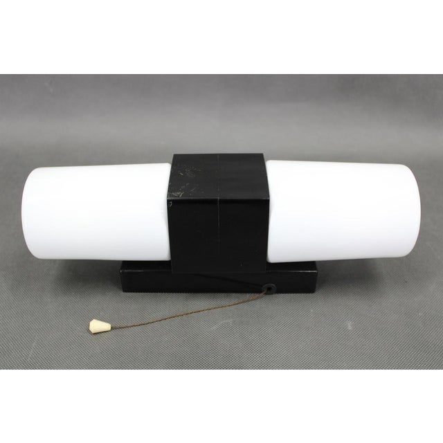 An elegant mid century modern wall light designed and produced in czechoslovakia during the 1960s. Crafted from black...