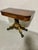 An impressive antique flip-top games table, New York circa 1820. With an impressive figured timber top bordered by an...