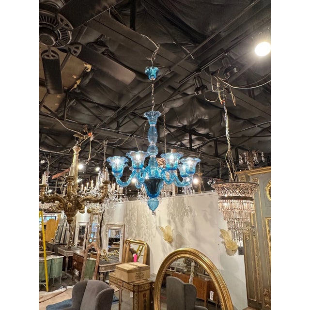 Decorative blue chandelier with brilliant blue Murano glass. A very unique fixture that is sure to impress!