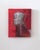 The artwork features a striking depiction of a medieval helmet against a vivid red background, evoking a sense of...