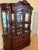 Absolutely stunning large, vintage-style carved wood china cabinet featuring an elaborate traditional design and...