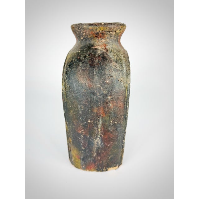 A beautifully rustic primitive clay vessel featuring a hand-carved swan relief motif, rendered in an expressive, textural...