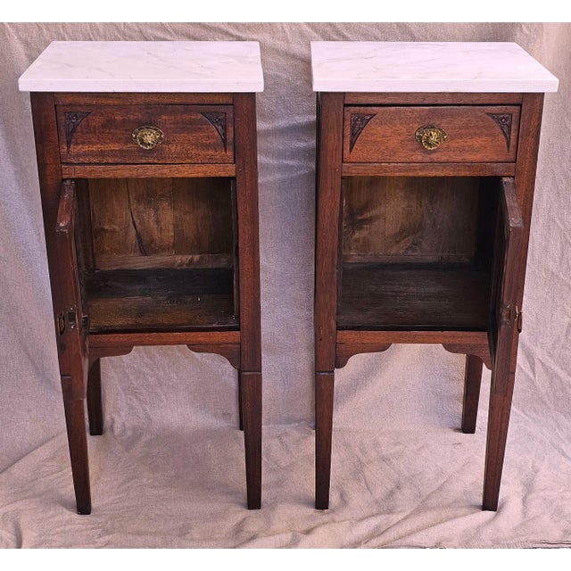 A beautifully matched pair of early 20th‑century English mahogany nightstands, dating to the 1910s, where the quiet...