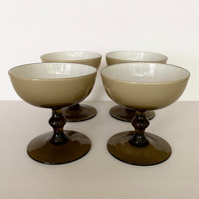 Vintage set of 4 Carlo Moretti cased glass champagne coupes. Smoked glass with white interior. A great retro set to add...