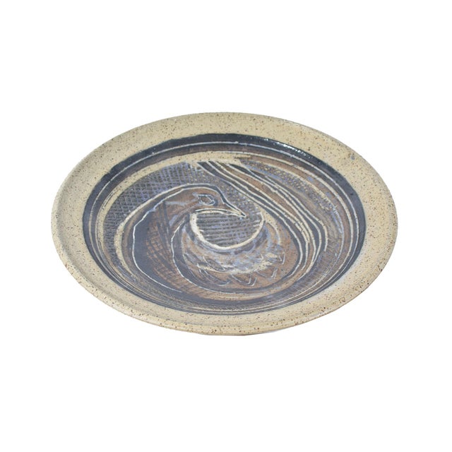 A decorative plate by American artist Charles Counts (1934-2000) for Beaver Ridge Studio Pottery. The rounded plate...